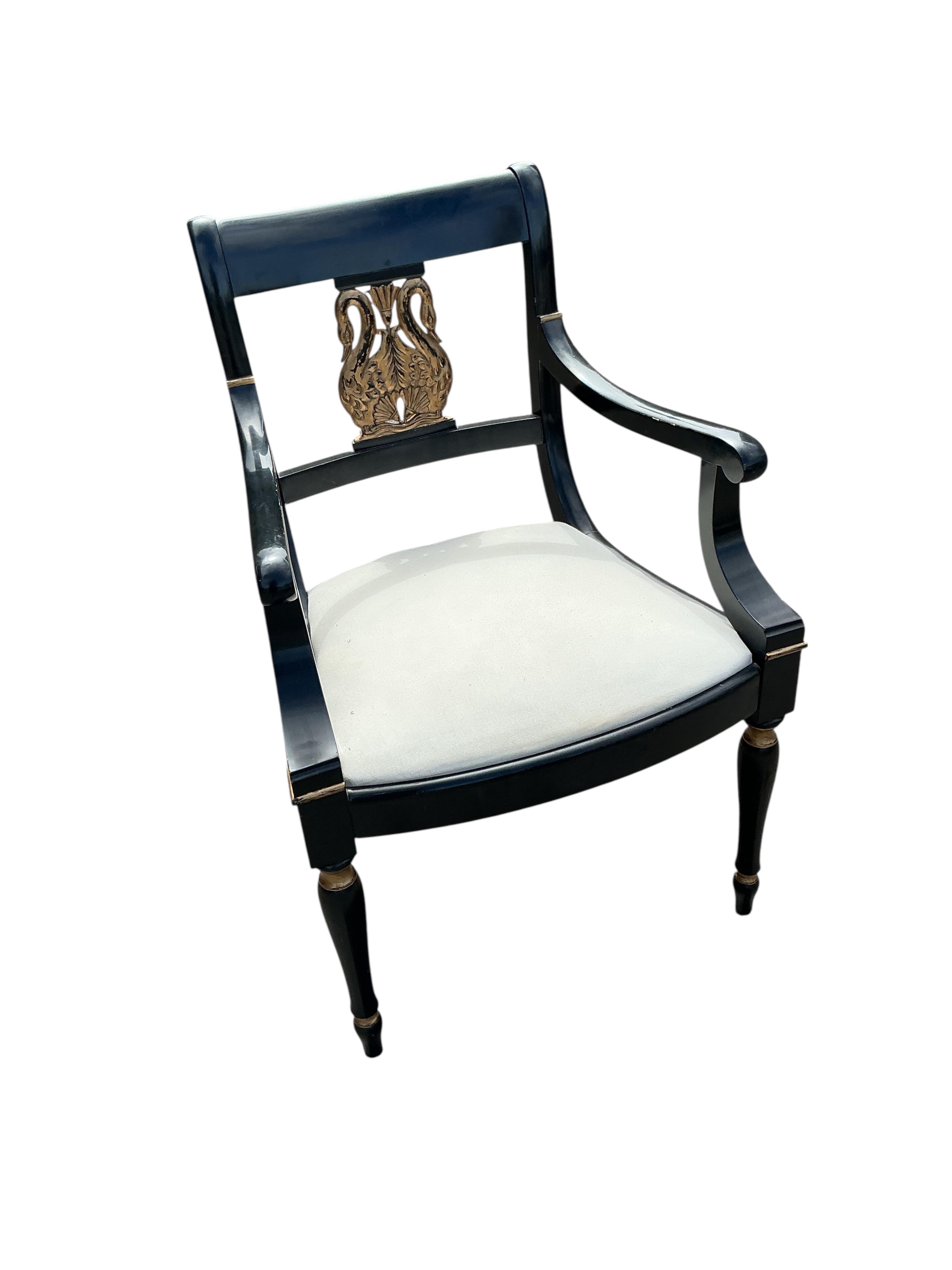 A set of six Empire style ebonised parcel gilt dining chairs, two with arms